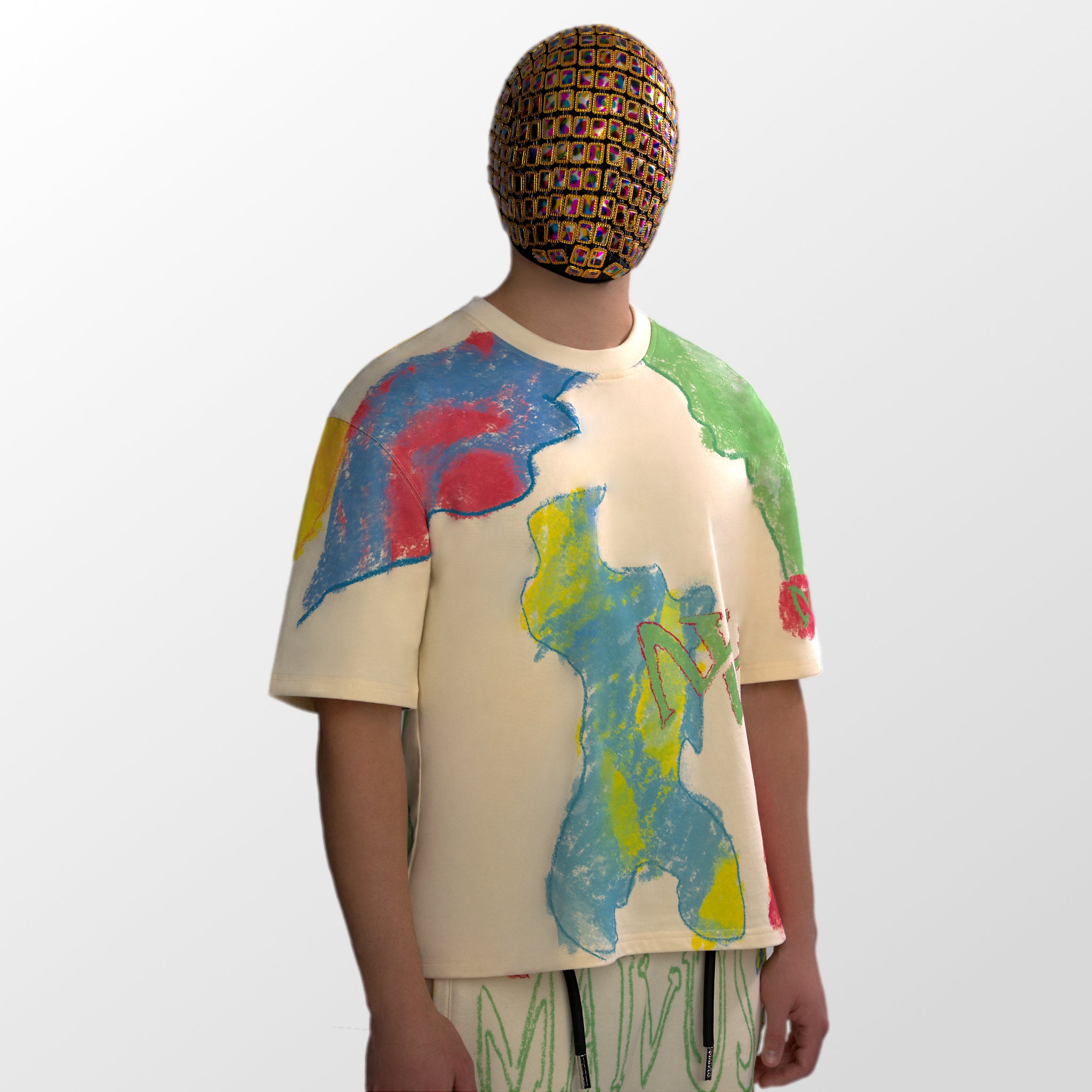 Model wearing the luxury multicolored t-shirt with abstract shapes and 'MAIVUS' branding from 'MAIVUS' against a white studio backdrop