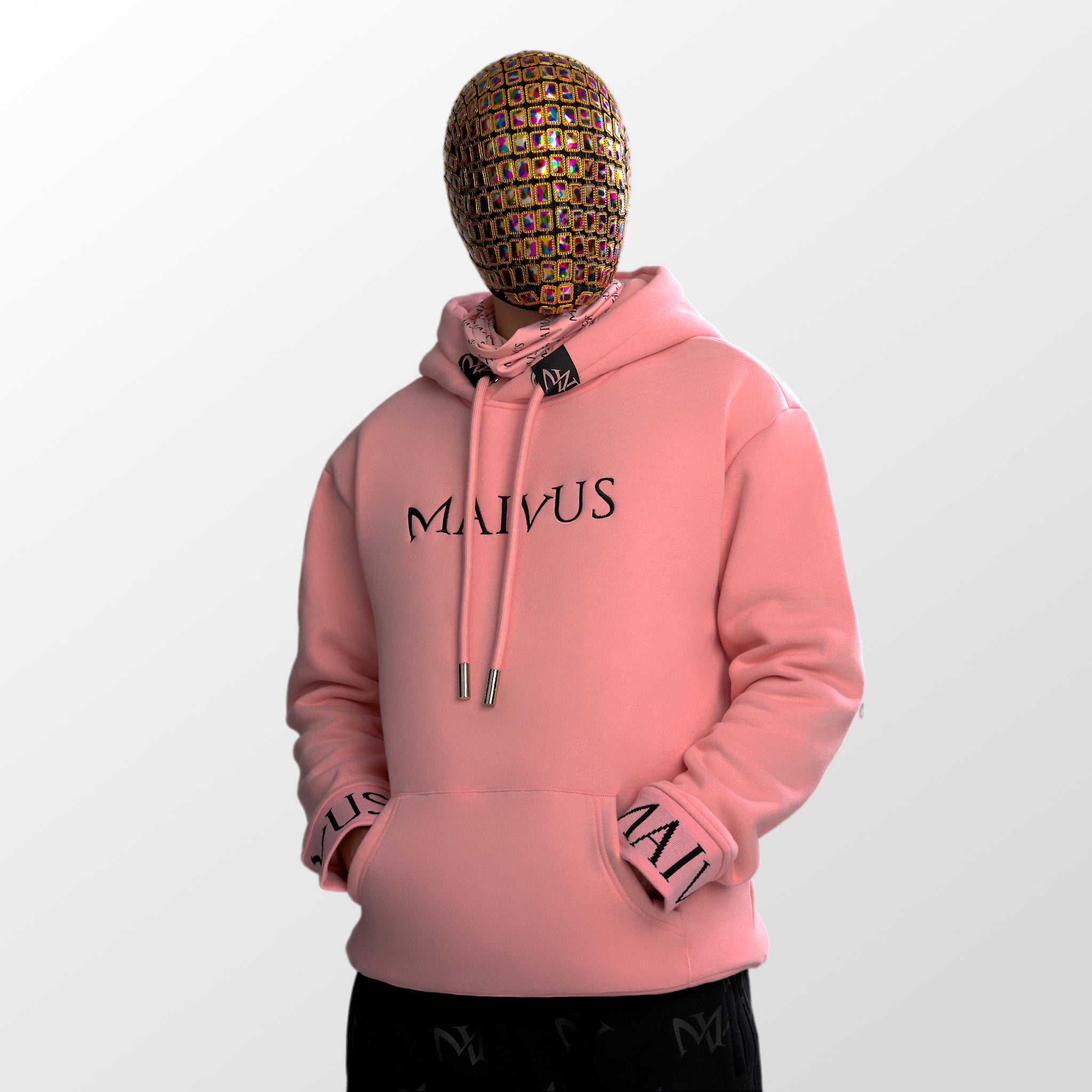 Model wearing a luxury pink and black hoodie with black embroidery and branded snood from 'MAIVUS' against a white studio backdrop