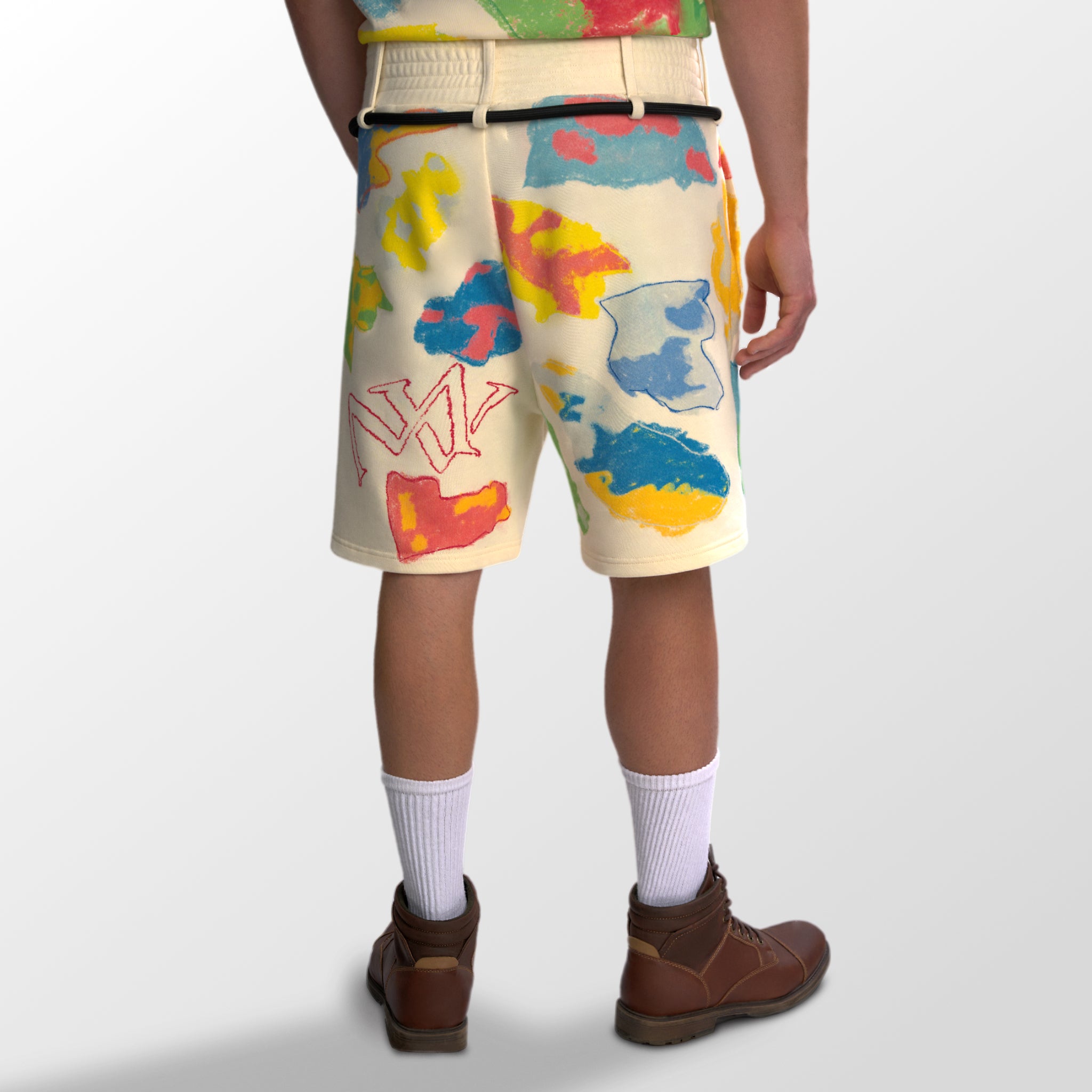Model wearing the luxury multicolored shorts with abstract shapes and 'MAIVUS' branding from 'MAIVUS' against a white studio backdrop