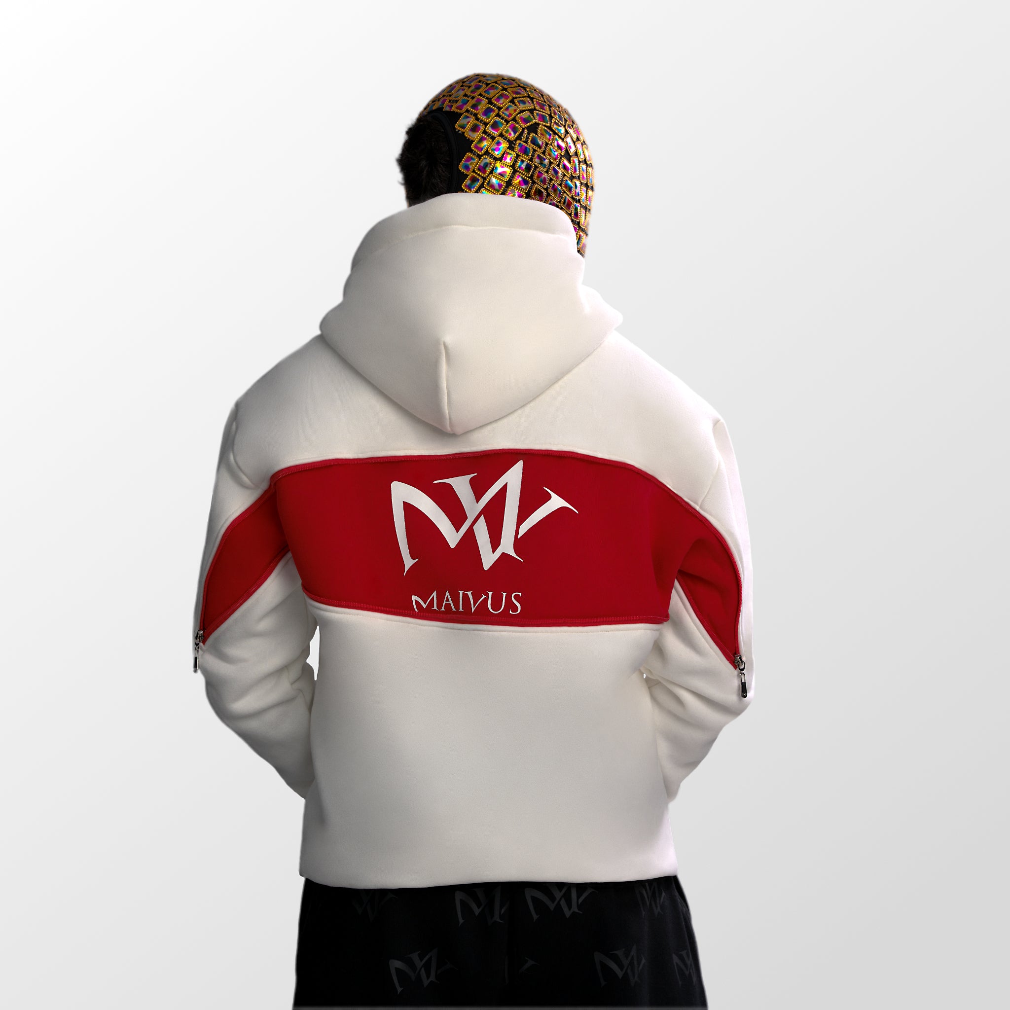 Model wearing a white and red luxury hoodie. Large 'MV' logo on back of hoodie from 'MAIVUS' against a white studio backdrop