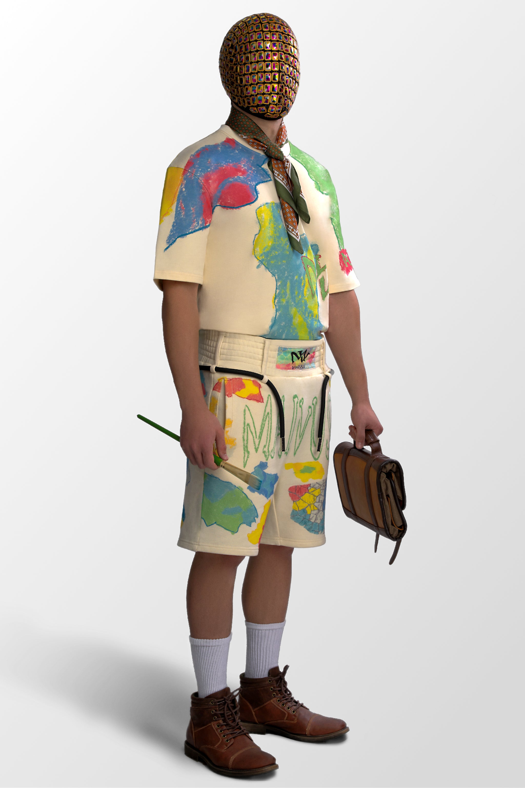 Model wearing the luxury multicolored t-shirt and shorts with abstract shapes and 'MAIVUS' branding from 'MAIVUS' against a white studio backdrop