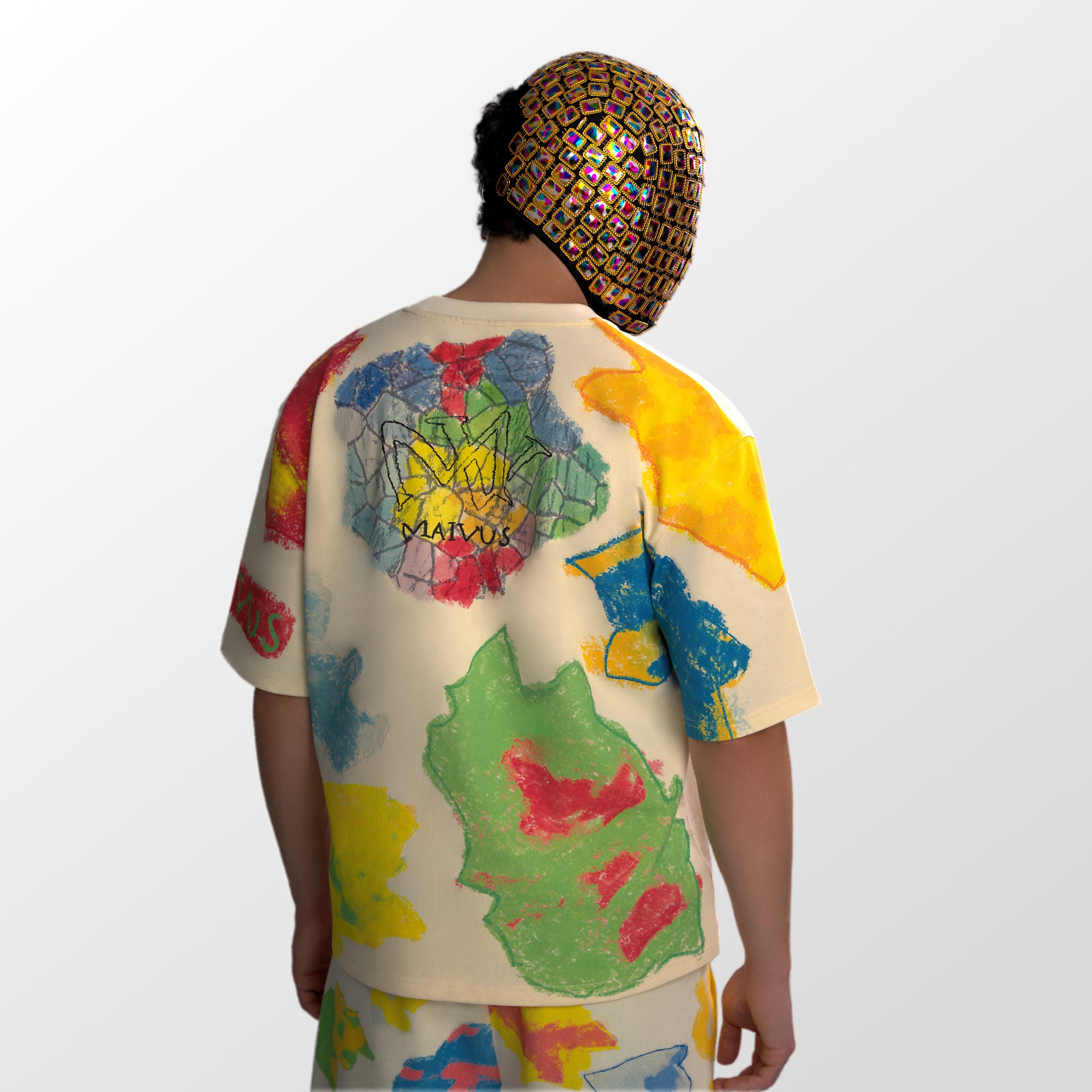 Model wearing the luxury multicolored t-shirt with abstract shapes and 'MAIVUS' branding from 'MAIVUS' against a white studio backdrop