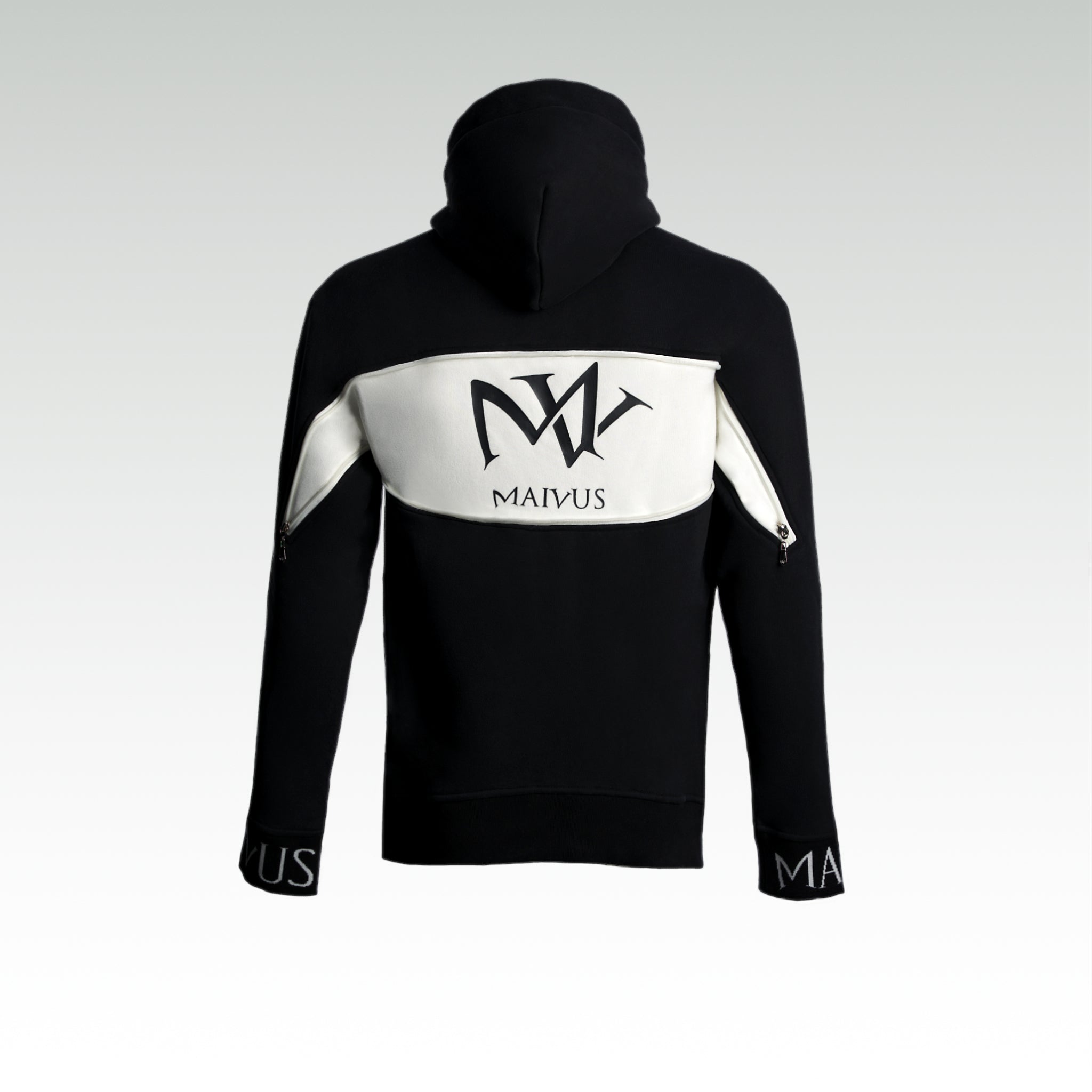 Close up of a black and white luxury hoodie. Large 'MV' logo on back of hoodie from 'MAIVUS' against a white studio backdrop
