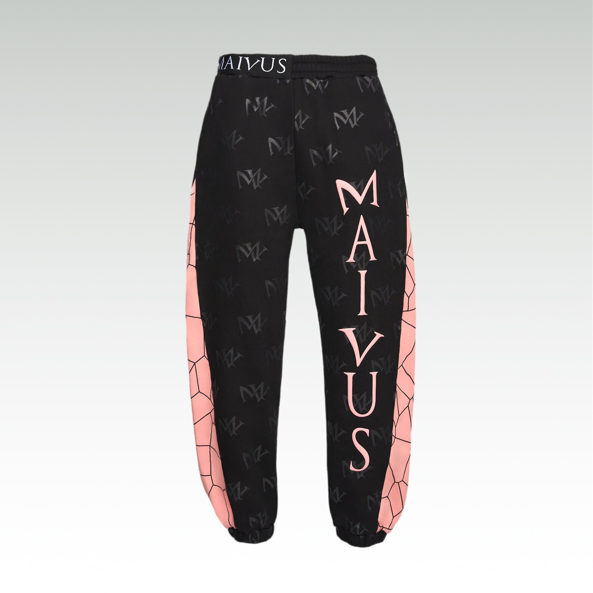 Close up of the luxury black and pink joggers with 'MV' branding and geometric shapes from 'MAIVUS' against a white studio backdrop