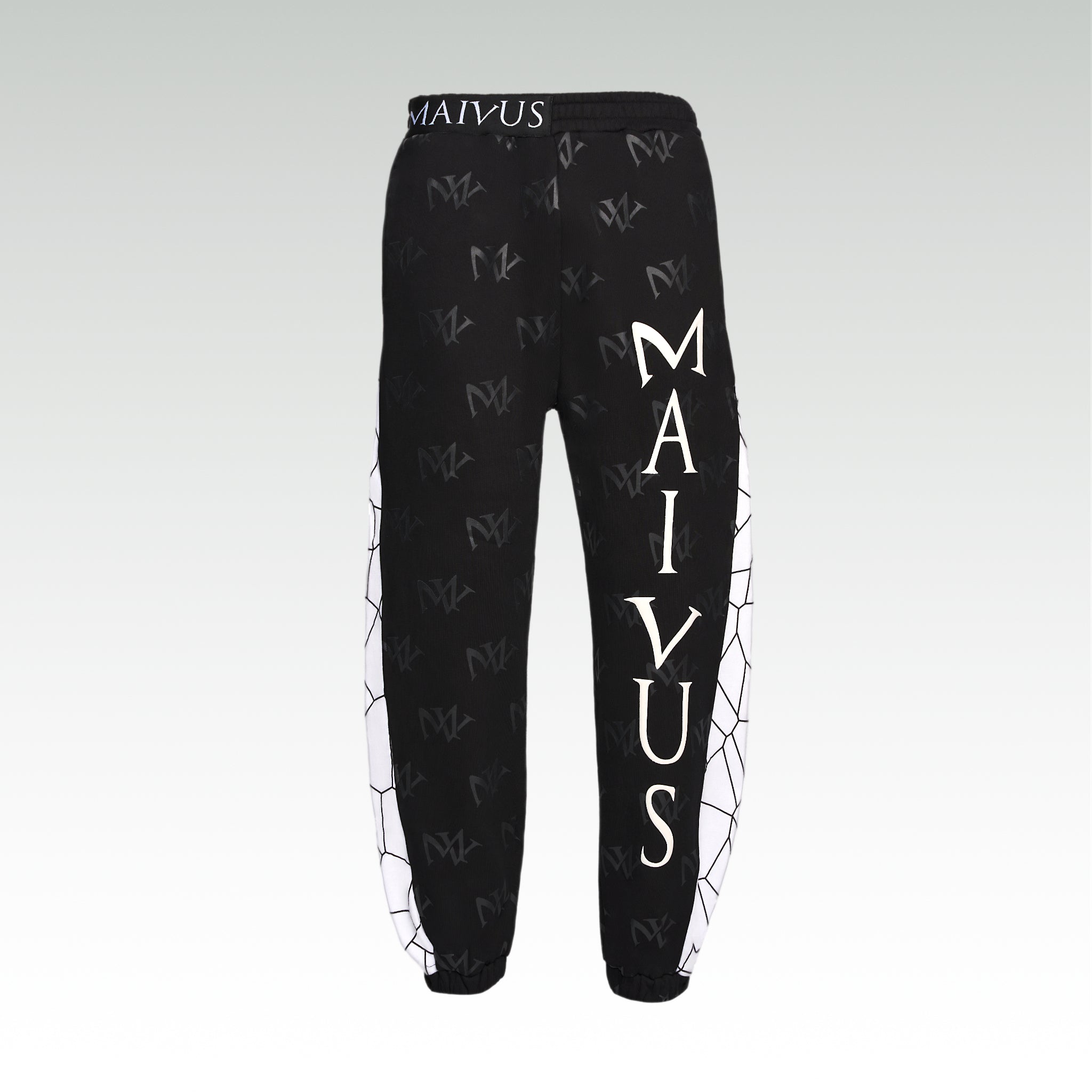 Close up of the luxury white and black joggers with 'MV' branding and geometric shapes from 'MAIVUS' against a white studio backdrop
